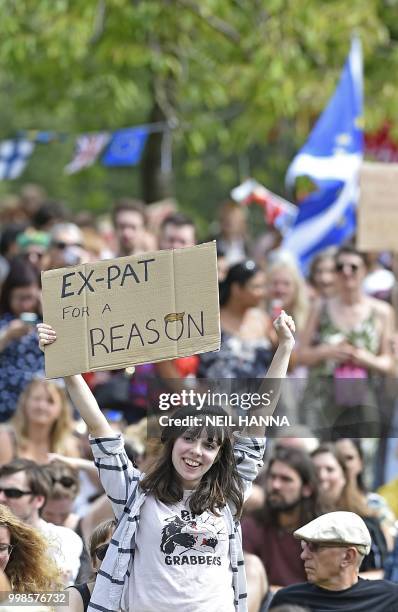 Protester holds up a placard as she takes part in the Scotland United Against Trump demonstration through the streets of Edinburgh, Scotland on July...