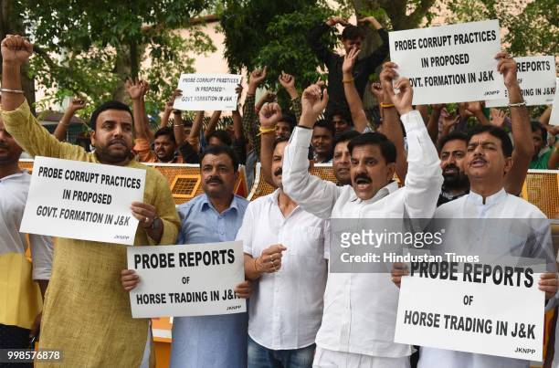 Activists and supporters of Jammu and Kashmir National Panthers Party shout slogan during a protest demanding probe into reports of horse trading in...