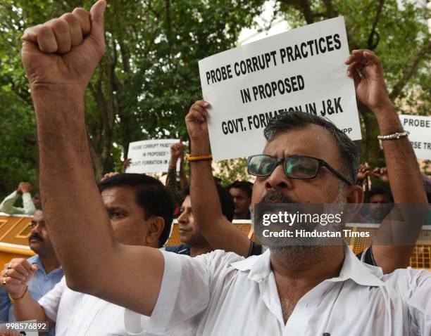 Activists and supporters of Jammu and Kashmir National Panthers Party shout slogan during a protest demanding probe into reports of horse trading in...