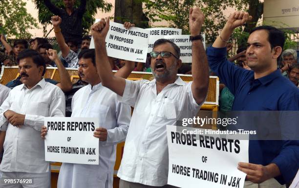 Activists and supporters of Jammu and Kashmir National Panthers Party shout slogan during a protest demanding probe into reports of horse trading in...