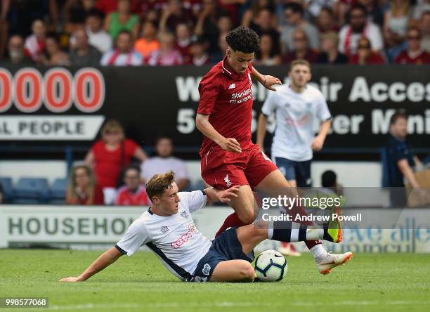 Curtis Jones of Liverpool competes with Callum Styles of Bury during the Pre-Season friendly match between Bury and Liverpool at Gigg Lane on July...