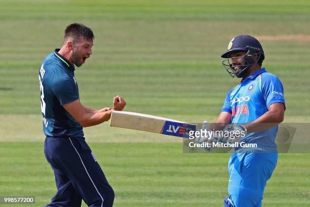 Mark Wood of England celebrates taking the wicket of Rohit Sharma of India during the 2nd Royal London One day International match between England...