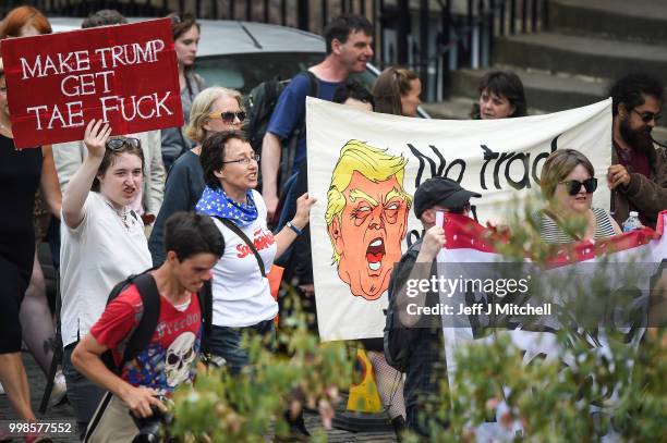 People march holding anti-Trump signs while the U.S. President is visiting Trump Turnberry Luxury Collection Resort in Scotland as people gather to...