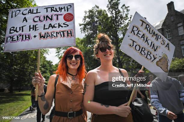 People march holding anti-Trump signs while the U.S. President is visiting Trump Turnberry Luxury Collection Resort in Scotland as people gather to...