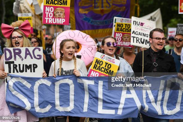 People march holding anti-Trump signs while the U.S. President is visiting Trump Turnberry Luxury Collection Resort in Scotland as people gather to...