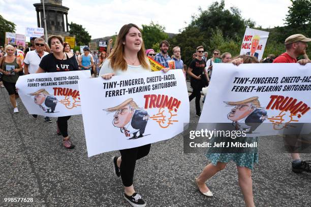 People march holding anti-Trump signs while the U.S. President is visiting Trump Turnberry Luxury Collection Resort in Scotland as people gather to...