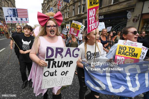 People march holding anti-Trump signs while the U.S. President is visiting Trump Turnberry Luxury Collection Resort in Scotland as people gather to...