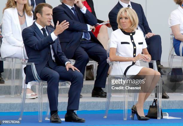 French President Emmanuel Macron and his wife Brigitte Macron attend the traditional Bastille Day military parade on the Champs-Elysees Avenue on...