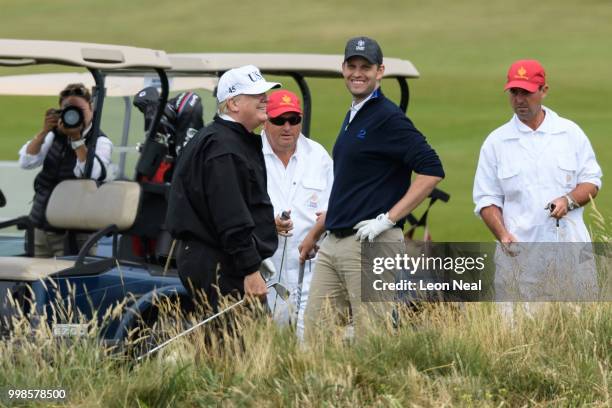 President Donald Trump and son Eric Trump play golf at Trump Turnberry Luxury Collection Resort during the President's first official visit to the...