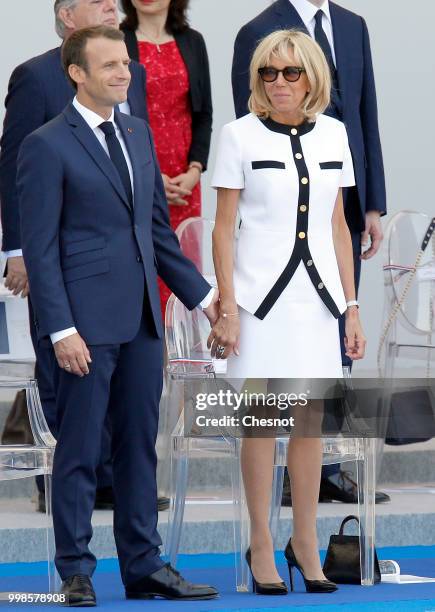 French President Emmanuel Macron and his wife Brigitte Macron attend the traditional Bastille Day military parade on the Champs-Elysees Avenue on...