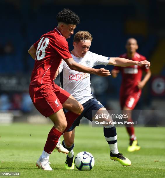 Curtis Jones of Liverpool competes with Callum Styles of Bury during the Pre-Season friendly match between Bury and Liverpool at Gigg Lane on July...
