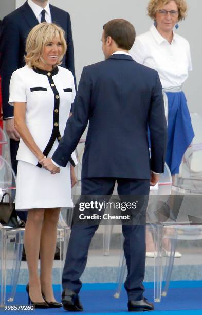 French President Emmanuel Macron and his wife Brigitte Macron attend the traditional Bastille Day military parade on the Champs-Elysees Avenue on...