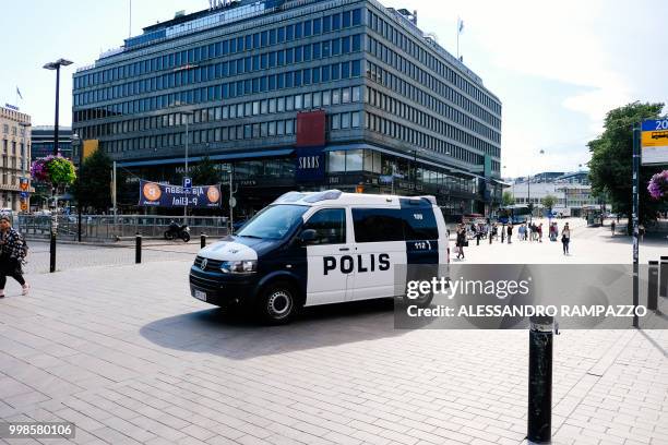 Police van patrols a street near the train station in Helsinki, Finland on July 14 ahead of the meeting between US President Donald Trump and his...