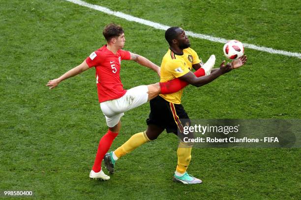 Romelu Lukaku of Belgium is tackled by John Stones of England during the 2018 FIFA World Cup Russia 3rd Place Playoff match between Belgium and...