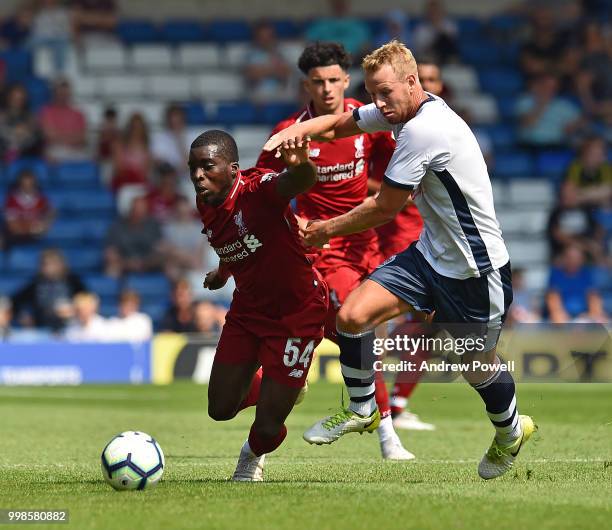 Sheyi Ojo of Liverpool competes with Adam Thompson of Bury during the Pre-Season friendly match between Bury and Liverpool at Gigg Lane on July 14,...