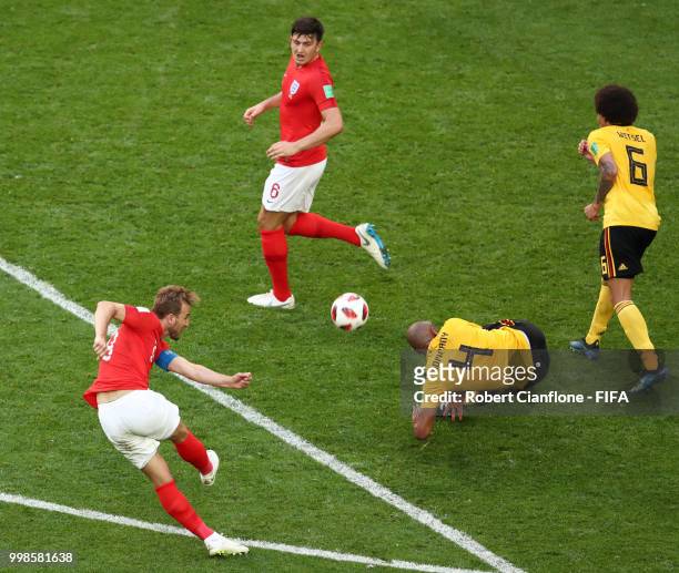 Harry Kane of England shoots past Vincent Kompany and Axel Witsel of Belgium during the 2018 FIFA World Cup Russia 3rd Place Playoff match between...