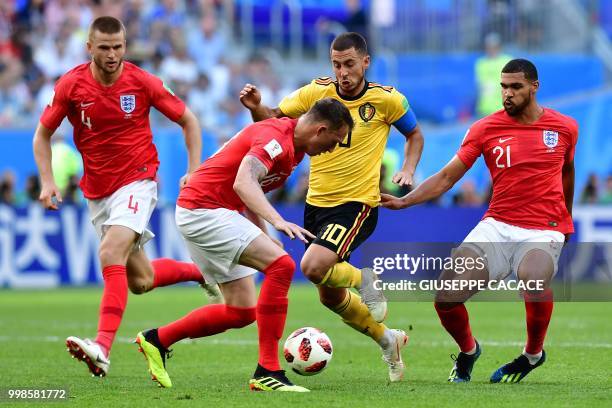 Belgium's forward Eden Hazard vies with England's midfielder Eric Dier , England's defender Phil Jones and England's midfielder Ruben Loftus-Cheek...