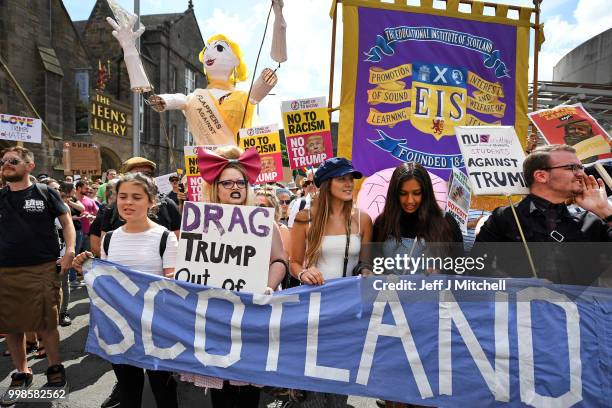 People march holding anti-Trump signs while the U.S. President is visiting Trump Turnberry Luxury Collection Resort in Scotland as people gather to...