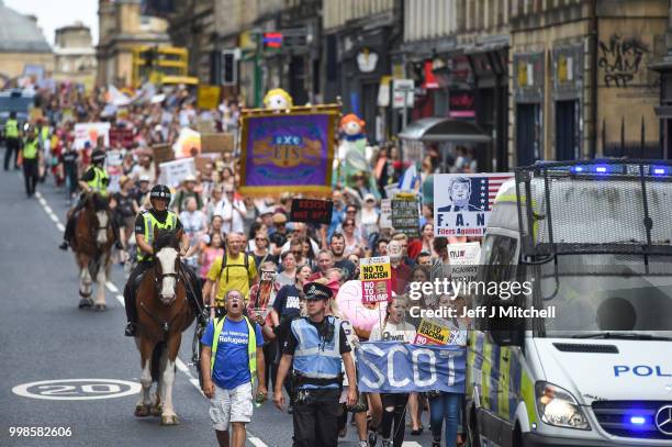 People march holding anti-Trump signs while the U.S. President is visiting Trump Turnberry Luxury Collection Resort in Scotland as people gather to...