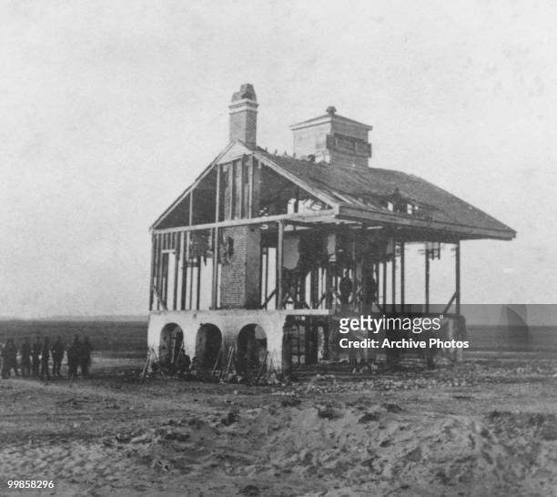 The battered Beacon house with it's walls and roof tiles missing on Morris Island, South Carolina circa 1864.