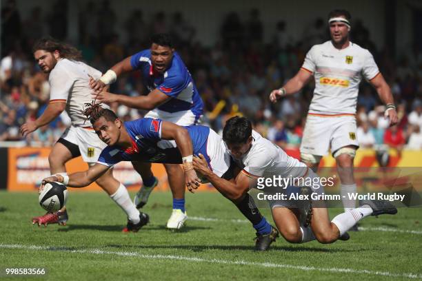 Melani Matavao of Samoa scores a try under pressure from Christopher Hilsenbeck of Germany during the Germany v Samoa Rugby World Cup 2019 qualifying...