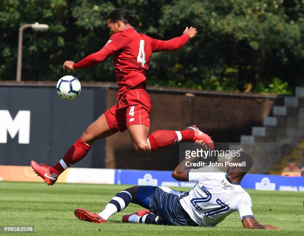 Virgil van Dijk of Liverpool competes with Gold Omotayo of Bury during the Pre-Season friendly match between Bury and Liverpool at Gigg Lane on July...