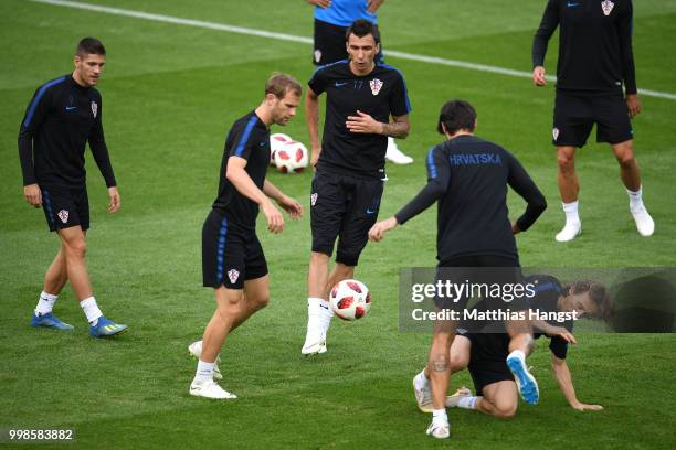 Luka Modric of Croatia tackles team mate Vedran Corluka of Croatia during Croatia training session during the 2018 FIFA World Cup at Luzhniki Stadium...