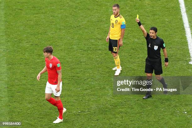 England's John Stones is shown a yellow card by Referee Alireza Faghani after a foul on Belgium's Eden Hazard during the FIFA World Cup third place...