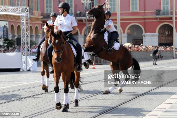 French mounted police tries to control her horse in Nice on July 14 during a ceremony for the second anniversary of attacks on the French coastal...