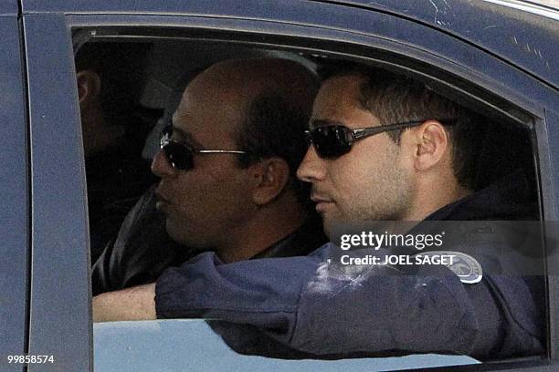Iranian agent Ali Vakili Rad is seen in a police vehicle while leaving Poissy, a Paris suburb, on May 18, 2010 after his release from the local...