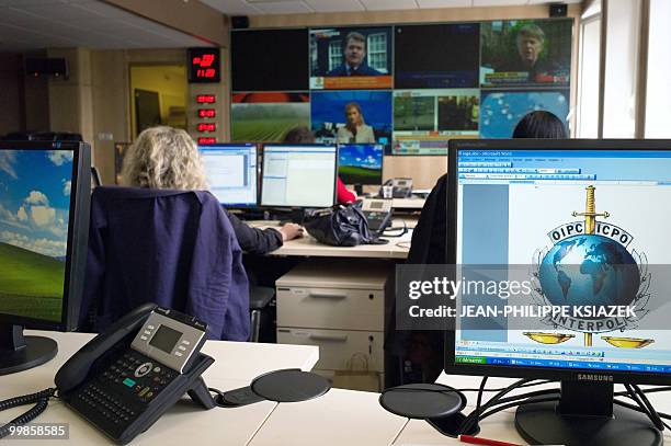 Picture taken on May 6, 2010 at Interpol headquarters in Lyon, eastern France, shows policemen controlling informations coming from other country...