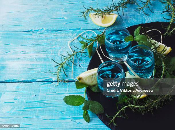 blue curacao liqueur or sambuca with lemon - blue curacao stock pictures, royalty-free photos & images