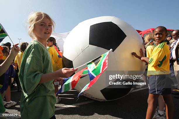 Giant inflatable football rolls down the street as teh Sandton police parade in preperation for the 2010 World Cup on May 17, 2010 in Sandton,...