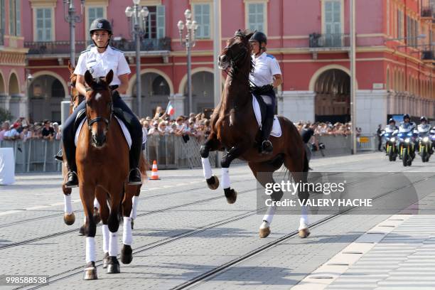 French mounted police tries to control her horse in Nice on July 14 during a ceremony for the second anniversary of attacks on the French coastal...