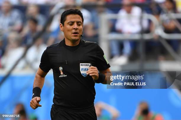 Iranian referee Alireza Faghani watches the teams play during their Russia 2018 World Cup play-off for third place football match between Belgium and...