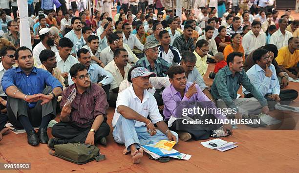 Indian applicants watch as a digital broadcasting screen gives results of a housing ballot in Mumbai on May 18, 2010. Local low-cost housing...