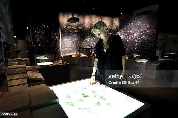 Woman uses an interactive display in the new 'Galleries of Modern London' exhibition, at the Museum of London on May 18, 2010 in London, England. The...