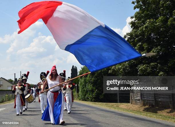 Villager dressed as Marianne, personification of the French Revolution, performs during Bastille Day celebrations on July 14, 2018 in Lavaré, western...