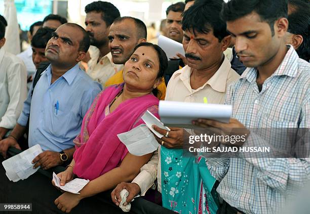 Indian applicants look at a board giving results of a housing ballot in Mumbai on May 18, 2010. Local low-cost housing authority, The Mumbai Housing...