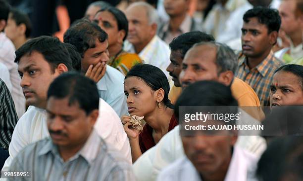 Indian applicants watch as a digital broadcasting screen gives results of a housing ballot in Mumbai on May 18, 2010. Local low-cost housing...