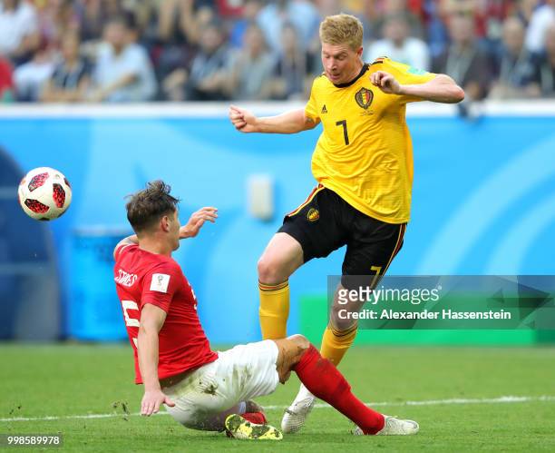 John Stones of England tackles Kevin De Bruyne of Belgium during the 2018 FIFA World Cup Russia 3rd Place Playoff match between Belgium and England...