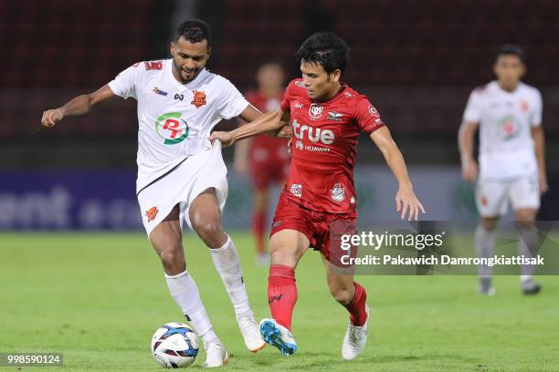 Jonatan Ferreira Reis of PT Prachuap FC and Puttinan Wannasri of True Bangkok United compete for the ball during the Thai League 1 match between True...