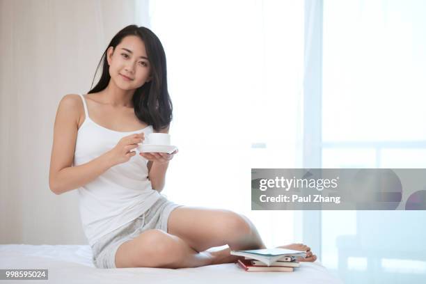 young woman in bedroom - young woman full body isolated stock pictures, royalty-free photos & images