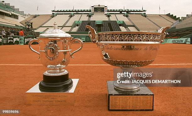 The trophies for the French Open men's and women's singles competition are seen 06 June on Center Court at the Roland Garros stadium in Paris. The...