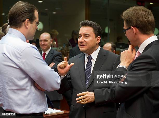 Ali Babacan, Turkey's deputy prime minister and economic minister, center, speaks with Anders Borg, Sweden's finance minister, left, and Jyrki...