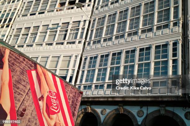 Colorful vintage CocaCola ad on the back of a truck contrasts with the facades along Avenida da Marina, next to Marina Coruna, aka known as Port...