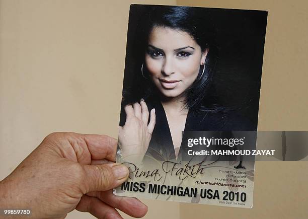 Afifa Fakih holds the picture of her niece Rima Fakih, a Lebanese-American who won the Miss USA pageant, at the latter's native village of Srifa in...