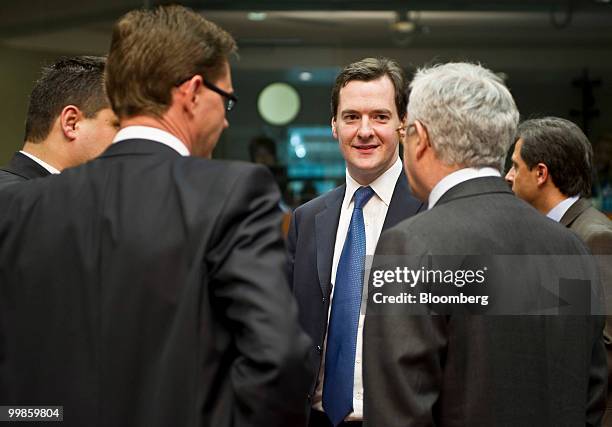 George Osborne, the U.K. Chancellor of the exchequer, center, speaks with colleagues during the meeting of European Union finance ministers in...
