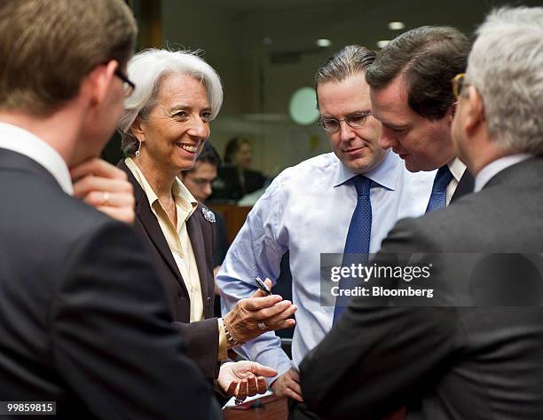 Christine Lagarde, France's finance minister, left, speaks with Anders Borg, Sweden's finance minister, center, and George Osborne, the U.K.'s...