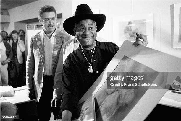 Dizzy Gillespie receives a book with drawings of Jazz musicians including himself by Piet Klaasse at the North Sea Jazz Festival in The Hague,...